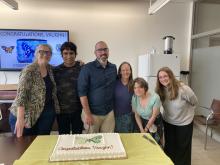 Dr. Shirey (middle) with Dr. Ries (far left) and other Ries lab members at post-defense celebration (With Cake)